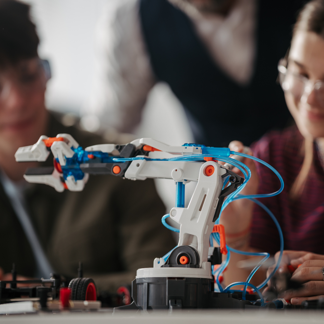 Teens building a robotic arm